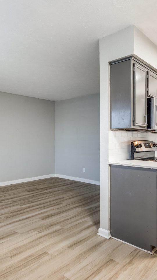 an empty kitchen with gray cabinets and stainless steel appliances at The Las Ventanas